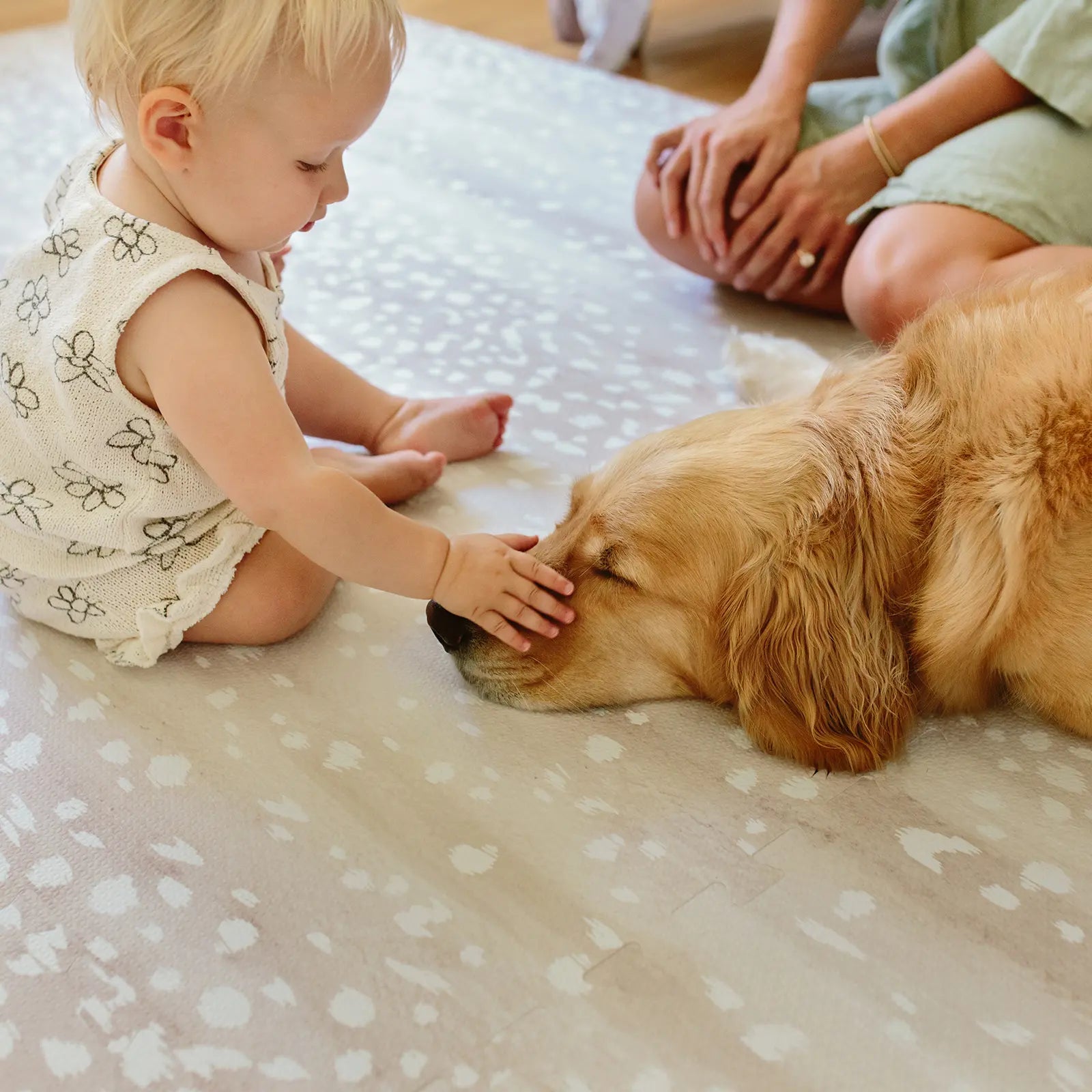 Fawn neutral beige animal print baby play mat shown with baby petting dog