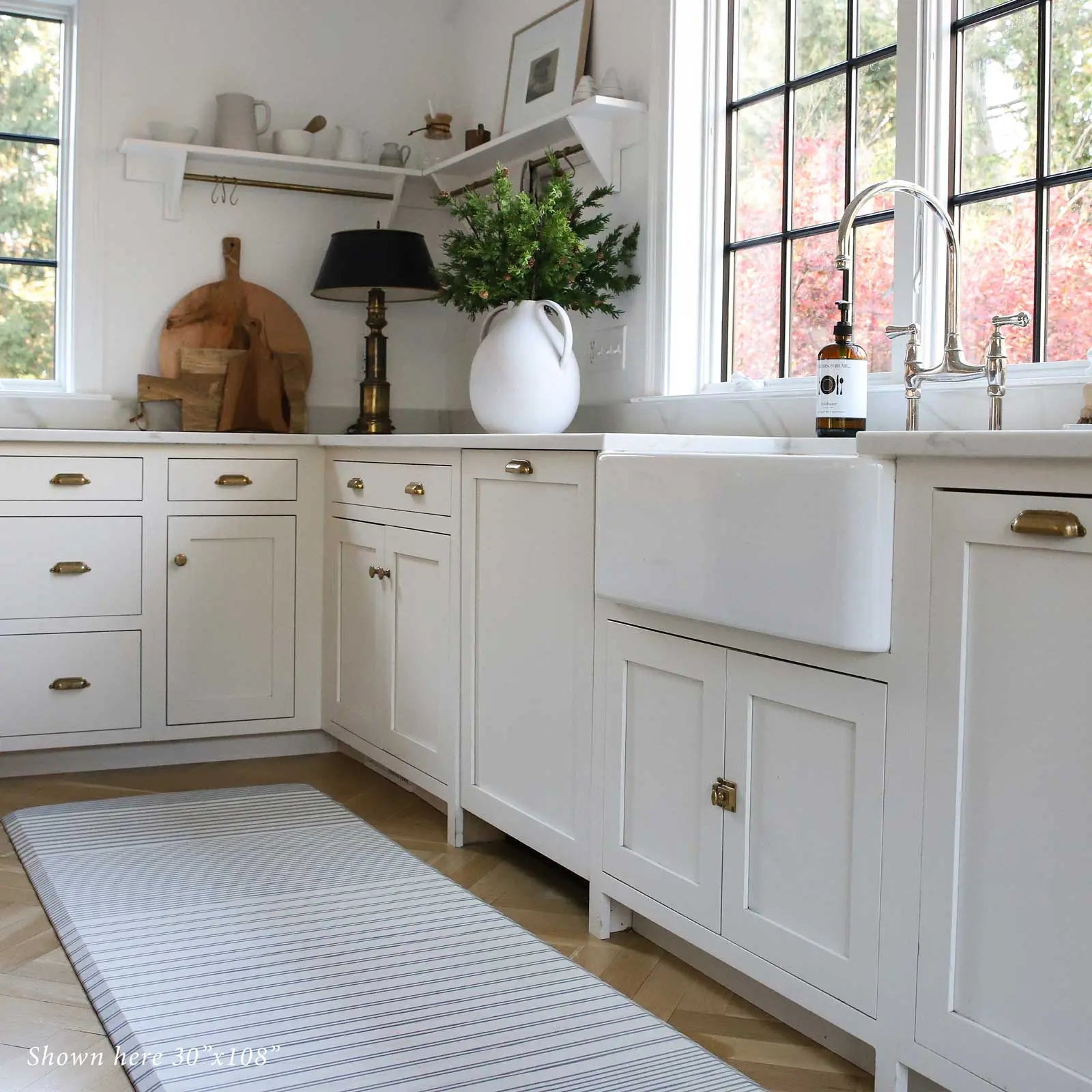 Blue and white minimal stripe kitchen mat in kitchen shown in size 30x108