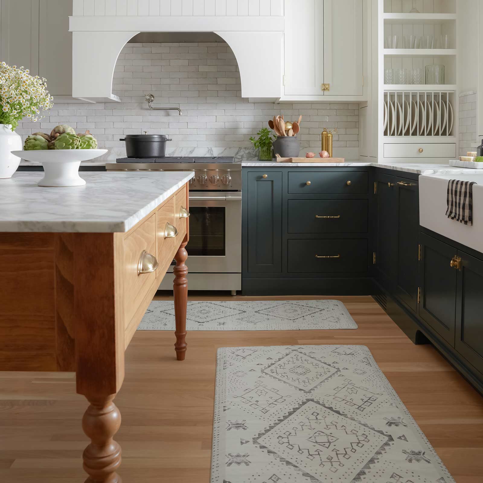 Ula avalon black and white boho print standing mat shown in a kitchen in sizes 30x72 and 22x72 placed in between the counters and the island