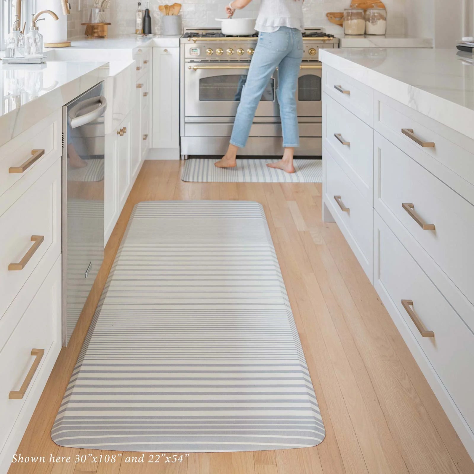 Blue and white minimal stripe kitchen mat in kitchen shown in 30x108 and 22x54 sizes.