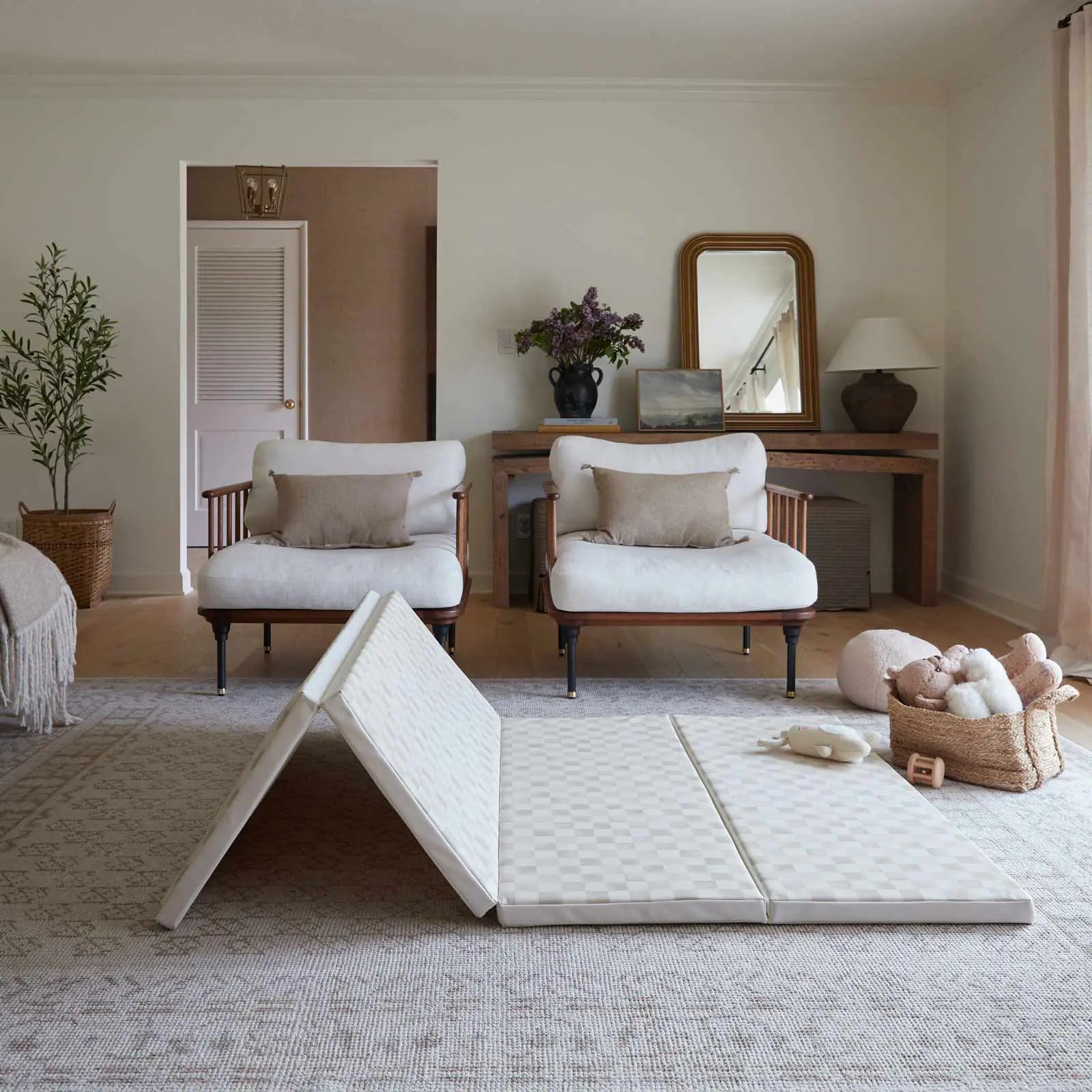 Almond neutral checker print tumbling mat shown in living room in size 4x6 with 2 panels folded to stand up