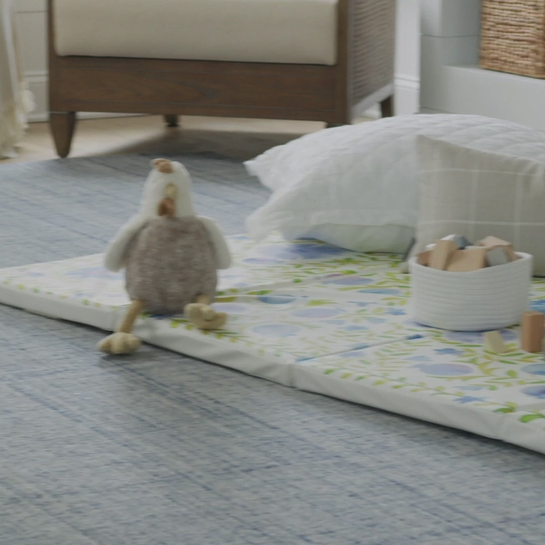 Video showing various shots of the bluebell blue and green floral tumbling mat being played and jumped on by toddlers