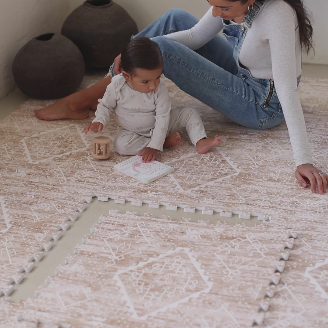 Video showing Ula boho minimal play mat in Amber brown, Sienna pink, and Straw tan