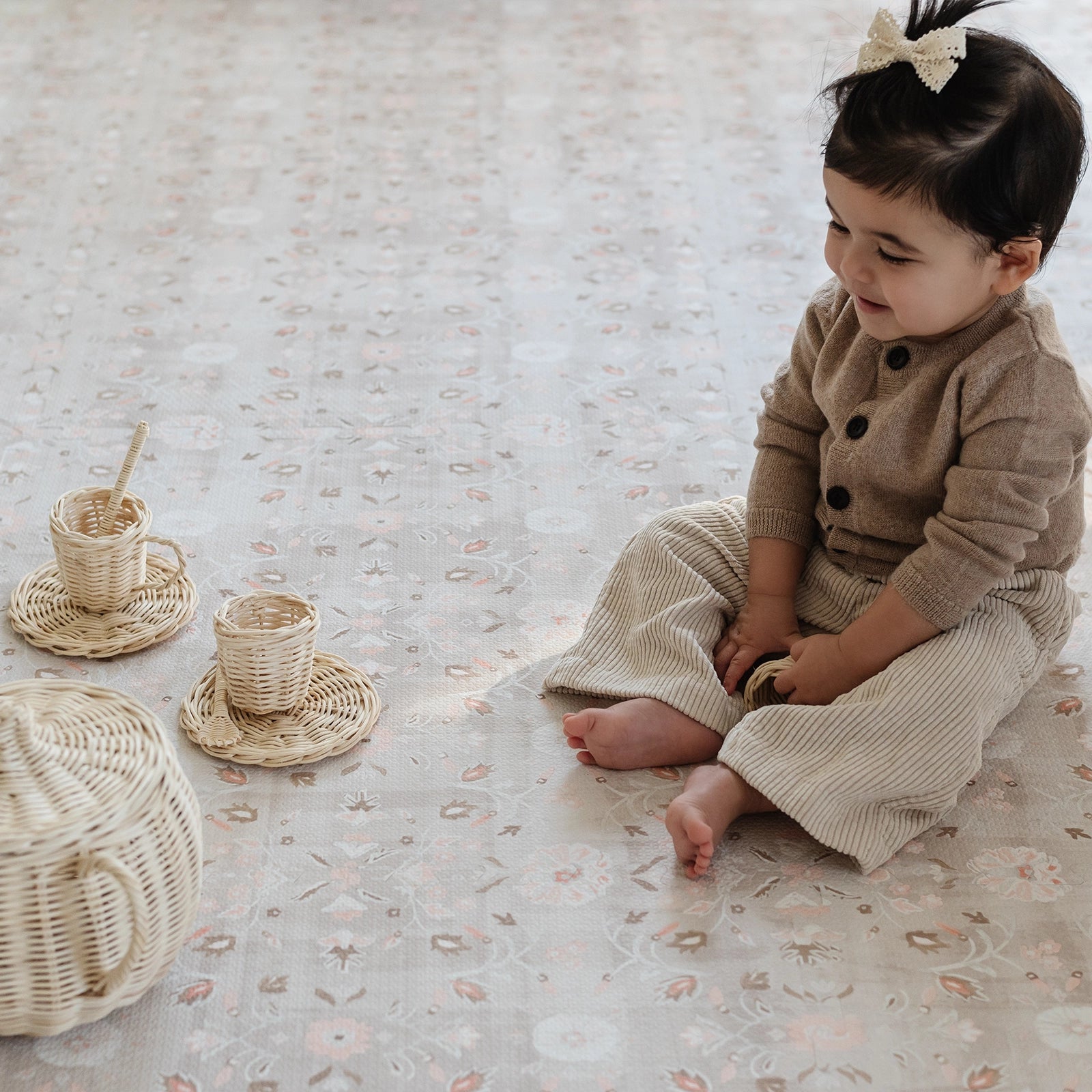 Linen beige and light pink floral baby play mat with baby girl play with tea set