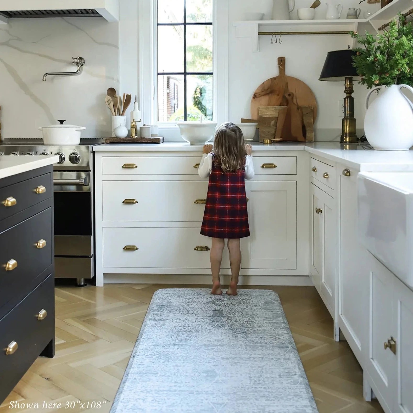 Gray neutral boho print kitchen mat with toddler in kitchen shown in size 30x108